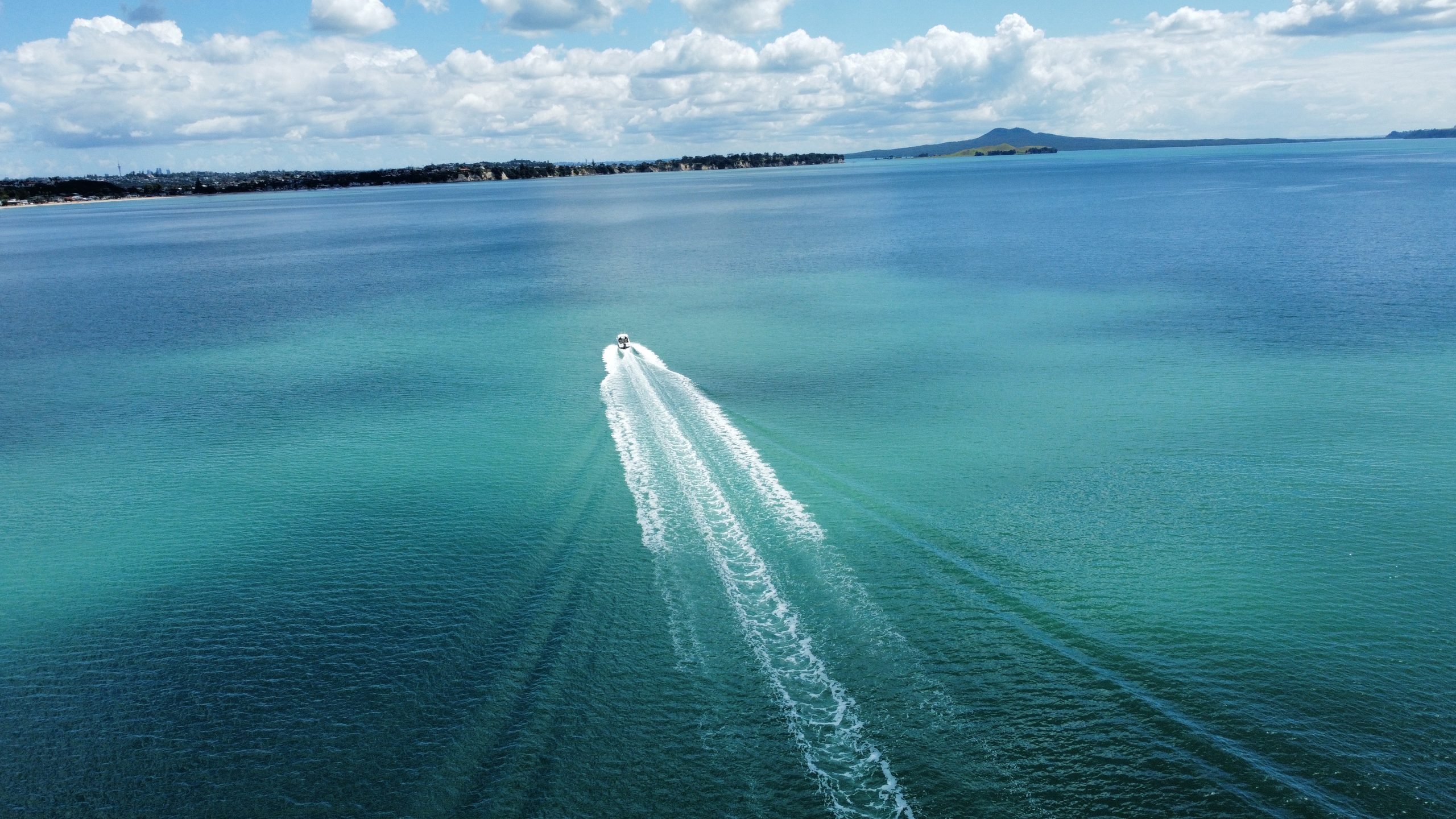 Daily boat cruising with Rangitoto in the background