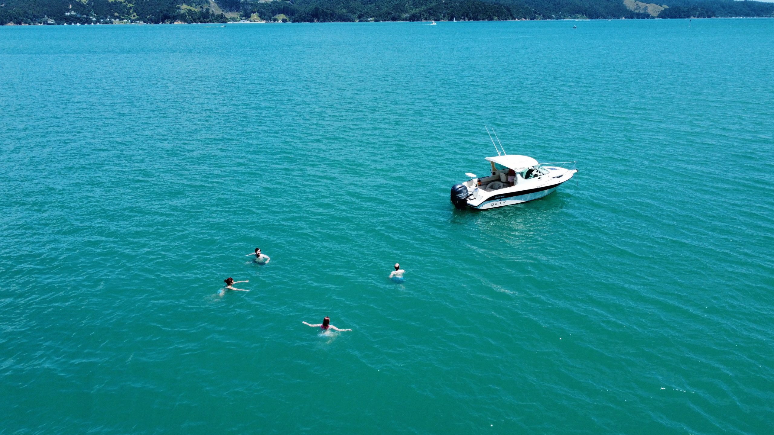 Daily Boats Buccaneer at anchor with swimmers in turquoise water