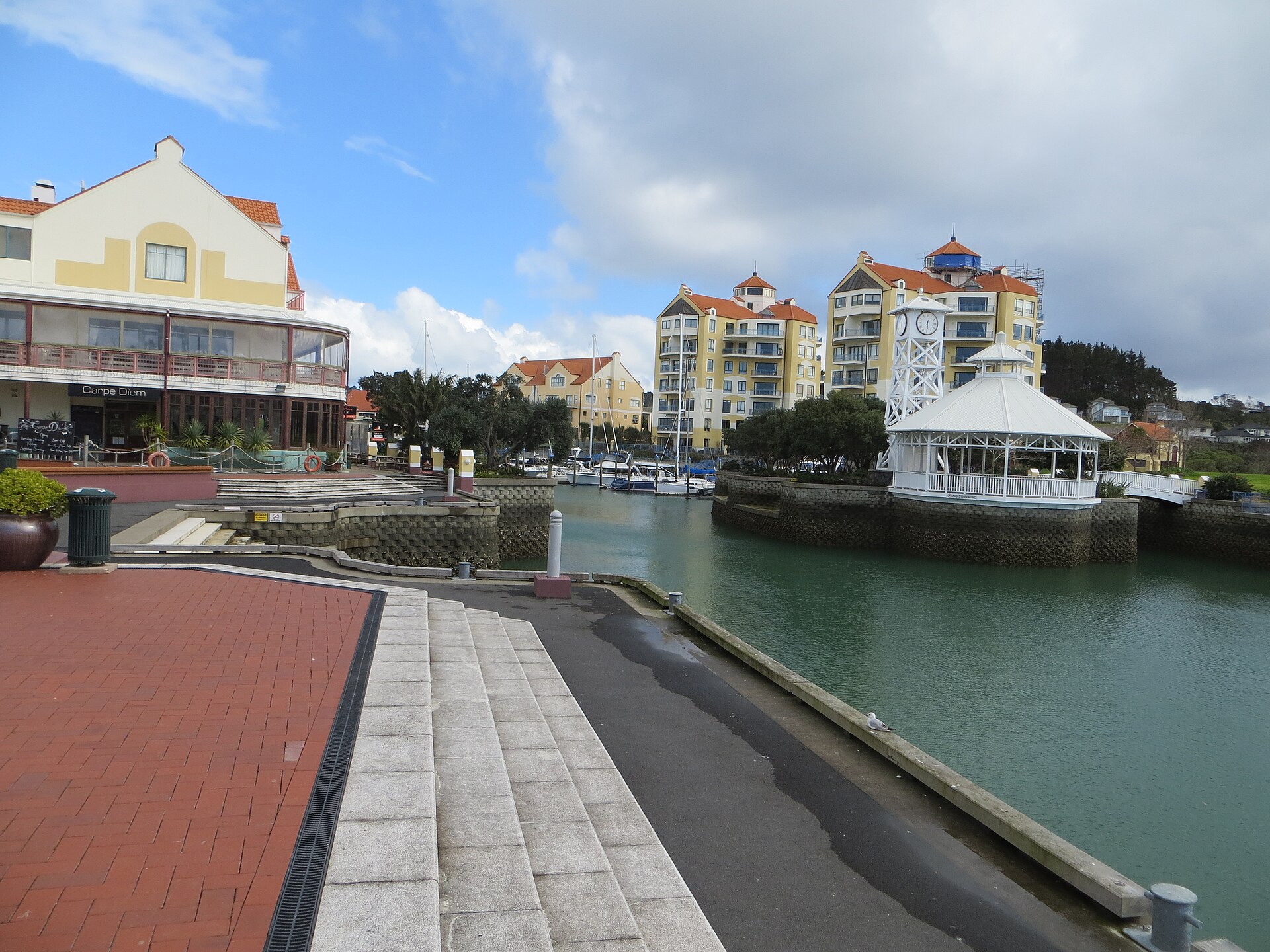 Waterfront buildings and boardwalk at the head of Gulf Harbour marina
