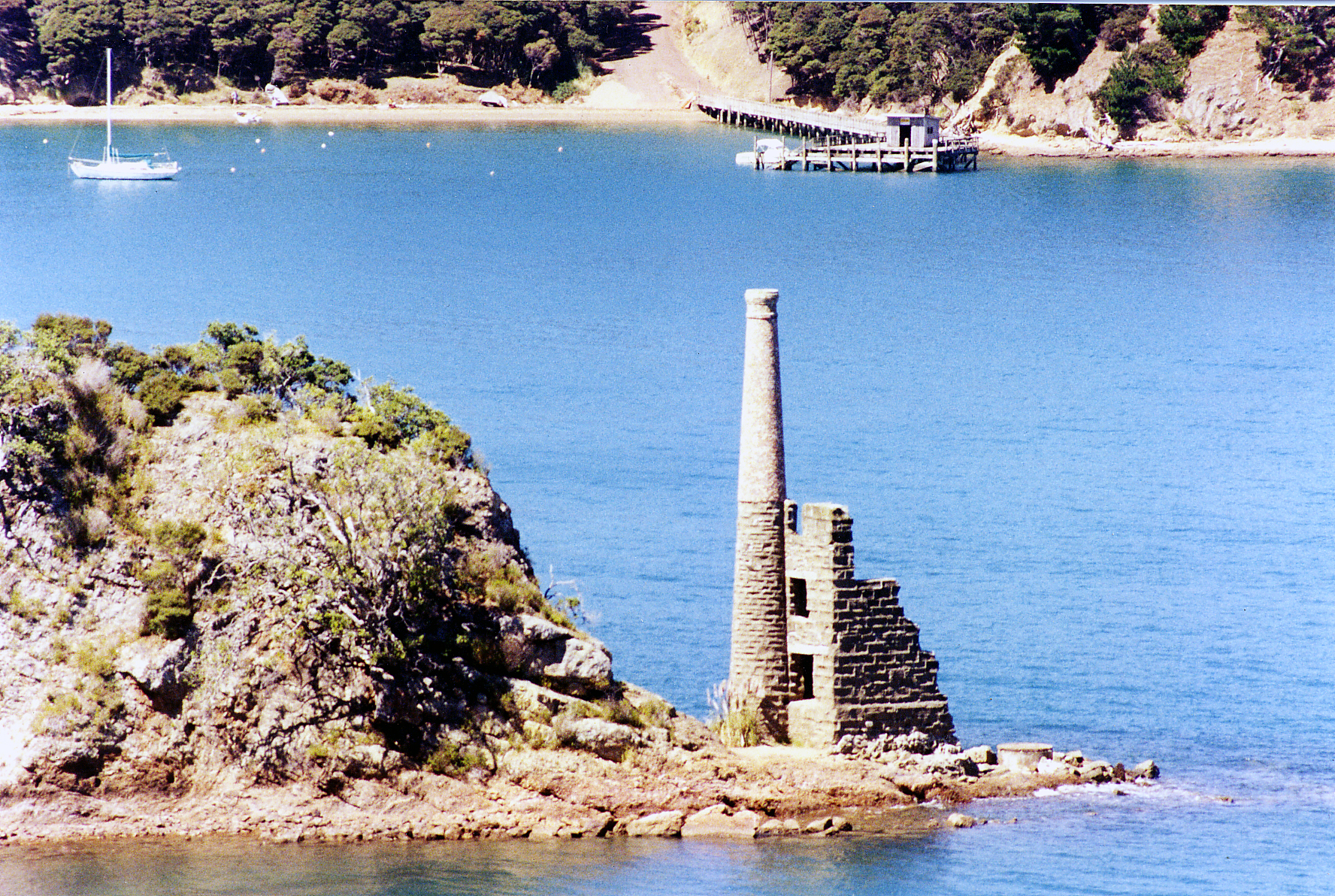 Ruins of the old copper mine pumphouse and chimney on the shore of Kawau Island